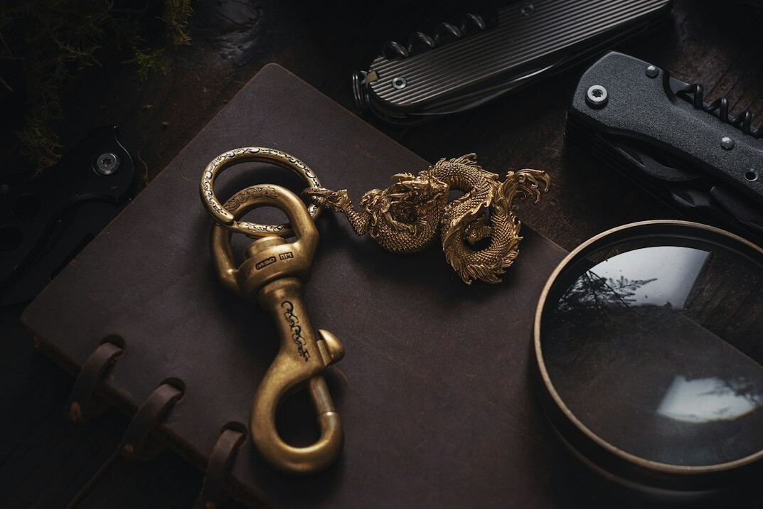 Detective notebook with magnifying glass and fountain pen on an old wooden desk